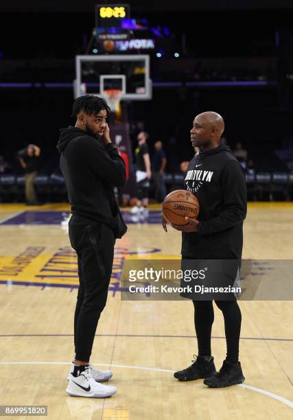 Angelo Russell of the Brooklyn Nets making his first come back to Staples Center talks with assistant coachJacque Vaughn during warms up before the...