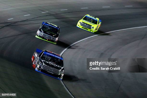 Ben Rhodes, driver of the Safelite Auto Glass Toyota, leads a pack of trucks during the NASCAR Camping World Truck Series JAG Metals 350 Driving...