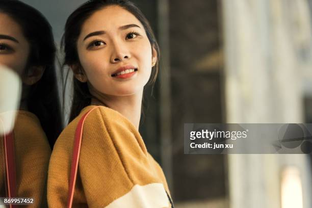 a young and beautiful woman was on the street - chinese model stock-fotos und bilder