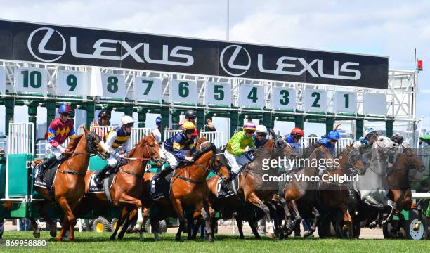 Stephen Baster riding Cismontane jumps out of barriers before winning Race 4, Lexus Stakes on Derby Day at Flemington Racecourse on November 4, 2017...