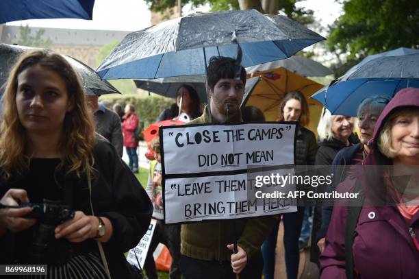 Protesters hold a rally before marching in Sydney to urge the Australian government to end the refugee crisis on Manus Island on November 4, 2017....