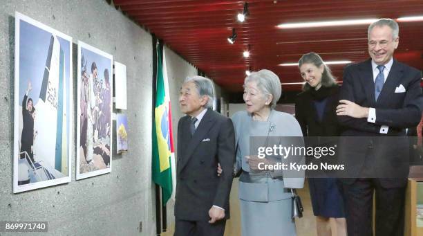 Emperor Akihito and Empress Michiko attend on Nov. 4 a photo exhibition being held at the Brazilian Embassy in Tokyo to mark the 50th anniversary of...