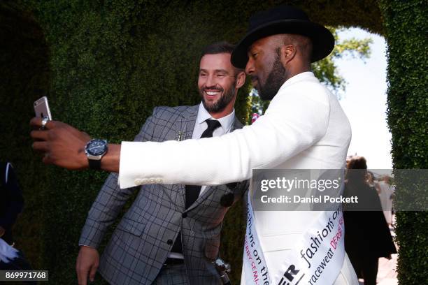 Men's Myer Fashions on the Field joint winner Gilles Belinga poses with Kris Smith at The Park on AAMI Victoria Derby Day at Flemington Racecourse on...