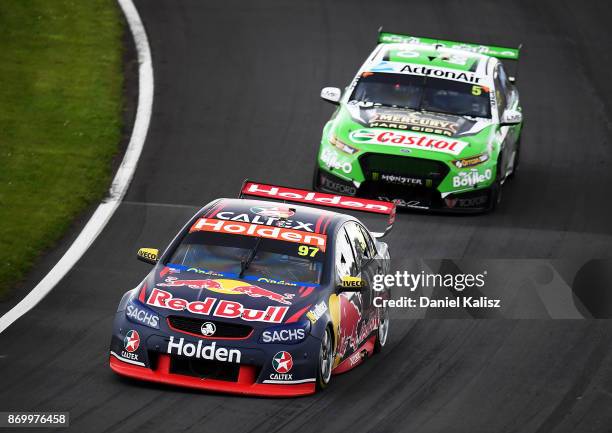 Shane Van Gisbergen drives the Red Bull Holden Racing Team Holden Commodore VF leads Mark Winterbottom drives the The Bottle-O Racing Ford Falcon FGX...