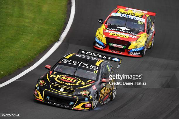 David Reynolds drives the Erebus Motorsport Penrith Racing Holden Commodore VF leads Chaz Mostert drives the Supercheap Auto Racing Ford Falcon FGX...