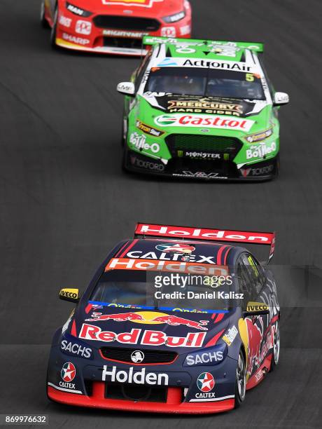 Shane Van Gisbergen drives the Red Bull Holden Racing Team Holden Commodore VF leads Mark Winterbottom drives the The Bottle-O Racing Ford Falcon FGX...