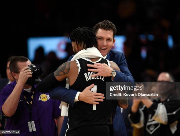 Coach Luke Walton of the Los Angeles Lakers hugs his former player D'Angelo Russell of the Brooklyn Nets, who made his first come back to Staples...