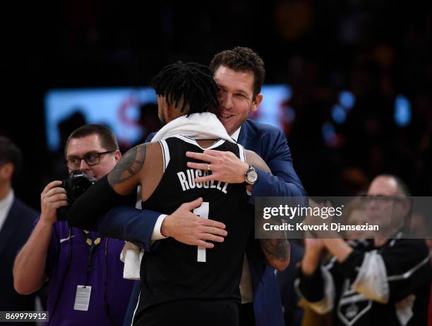 Coach Luke Walton of the Los Angeles Lakers hugs his former player D'Angelo Russell of the Brooklyn Nets, who made his first come back to Staples...