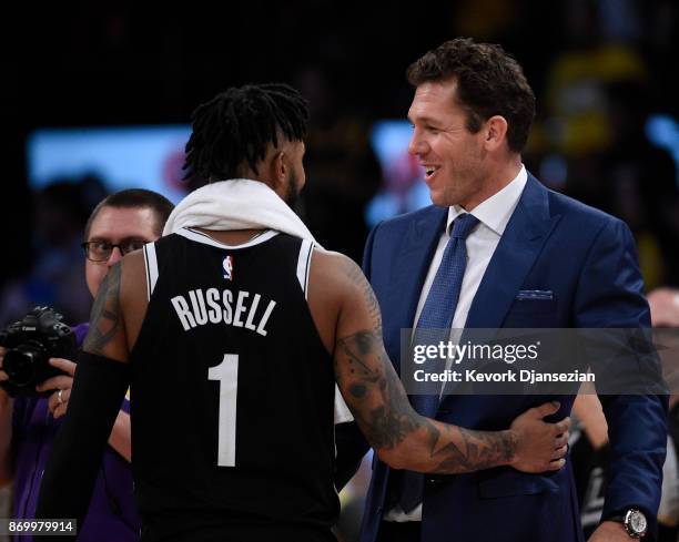 Coach Luke Walton of the Los Angeles Lakers hugs his former player D'Angelo Russell of the Brooklyn Nets, who made his first come back to Staples...