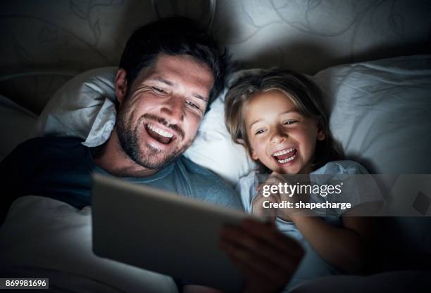 making bedtime fun time with wireless technology - bedtime stock pictures, royalty-free photos & images