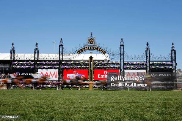 The field runs past the winning post for the first time in the Lexus Stakes on Derby Day at Flemington Racecourse on November 4, 2017 in Melbourne,...