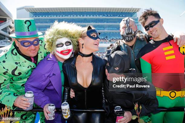 Racegoers dressed as superheroes and villains enjoy the perfect weather on Derby Day at Flemington Racecourse on November 4, 2017 in Melbourne,...