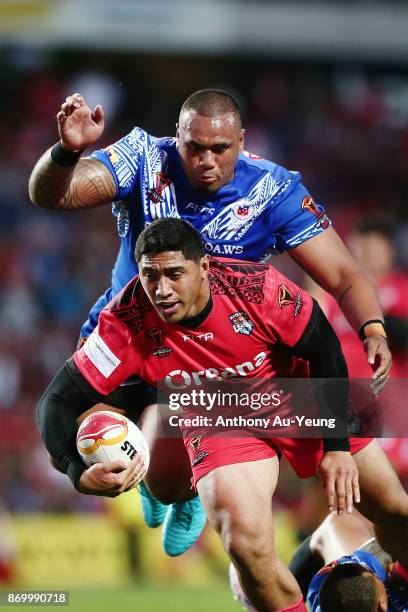 Jason Taumalolo to is tackled by Junior Paulo of Samoa during the 2017 Rugby League World Cup match between Samoa and Tonga at Waikato Stadium on...