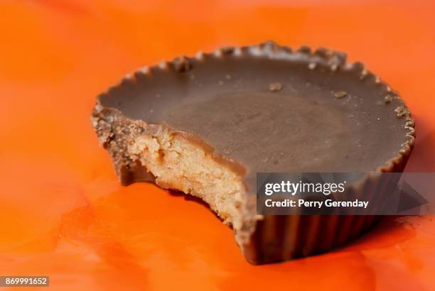 peanut butter cup with bite - halloween candy stock-fotos und bilder