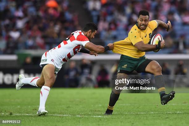 Samu Kerevi of the Wallabies is tackled during the international match between Japan and Australia at Nissan Stadium on November 4, 2017 in Yokohama,...