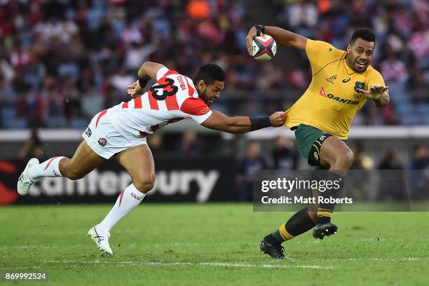 Samu Kerevi of the Wallabies is tackled during the international match between Japan and Australia at Nissan Stadium on November 4, 2017 in Yokohama,...
