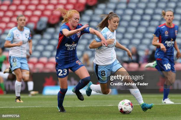 Tori Huster of the Jets contests the ball against Amy Harrison of Sydney FC during the round two W-League match between the Newcastle Jets and Sydney...