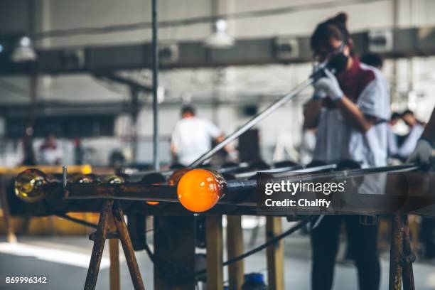 traditional glassblowing worker blowing glass - glass blowing stock pictures, royalty-free photos & images