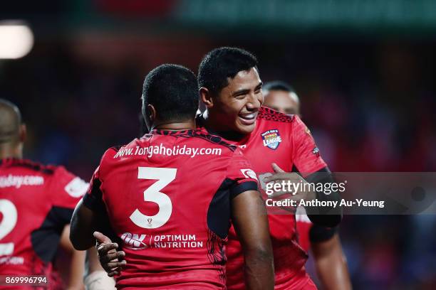 Jason Taumalolo of Tonga congratulates teammate Michael Jennings on his try during the 2017 Rugby League World Cup match between Samoa and Tonga at...