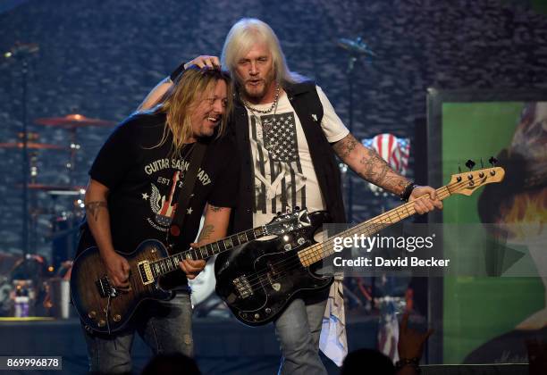 Guitarist Pete Evick and bassist Eric Brittingham of the Bret Michaels Band perform at The Joint inside the Hard Rock Hotel & Casino on November 3,...