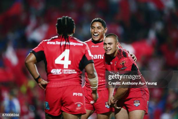 Jason Taumalolo of Tonga celebrates with teammates Tuimoala Lolohea and Solomone Kata after winning the 2017 Rugby League World Cup match between...