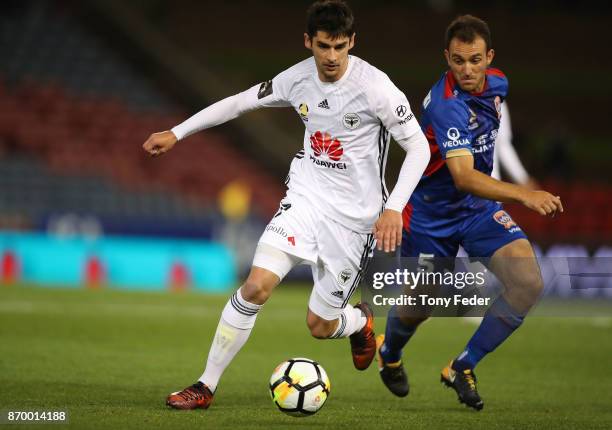 Guilherme Finkler of the Phoenix contests the ball with Ben Kantarovski of the Jets during the round five A-League match between the Newcastle Jets...