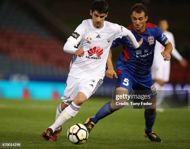 Guilherme Finkler of the Phoenix contests the ball with Ben Kantarovski of the Jets during the round five A-League match between the Newcastle Jets...