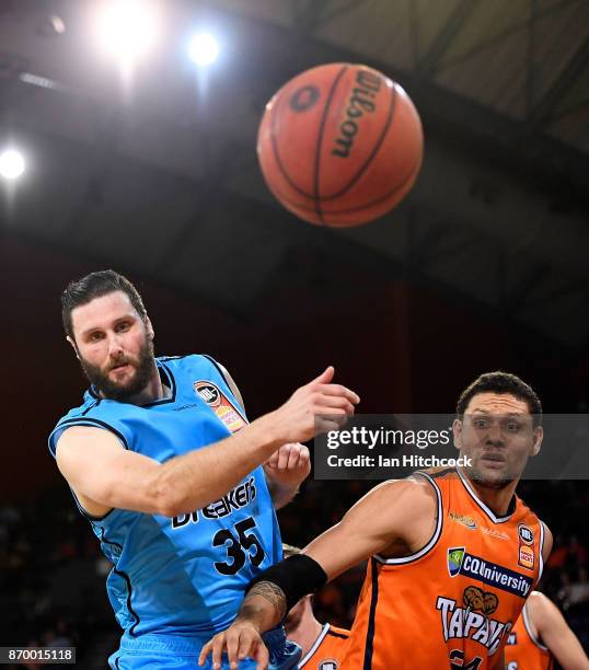 Michael Carrera of the Taipans and Alex Pledger of the Breakers contest the ball during the round five NBL match between the Cairns Taipans and the...