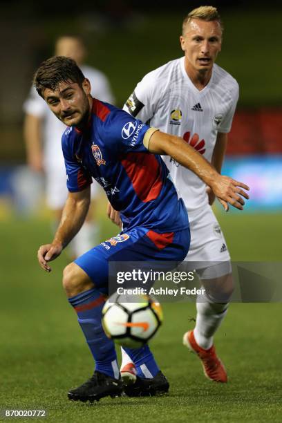 Goran Paracki of the Phoenix tackles Ivan Vujica of the Jets during the round five A-League match between the Newcastle Jets and the Wellington...