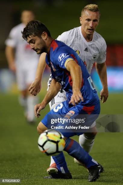 Goran Paracki of the Phoenix tackles Ivan Vujica of the Jets during the round five A-League match between the Newcastle Jets and the Wellington...