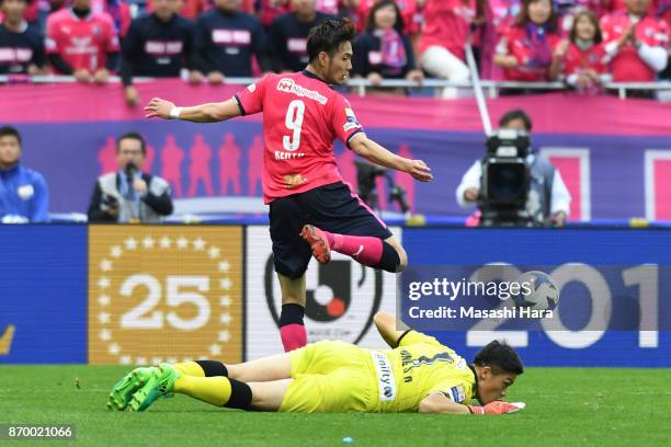 Kenyu Sugimoto of Cerezo Osaka and Jung Sung Ryong of Kawasaki Frontale compete for the ball during the J.League Levain Cup final match between...