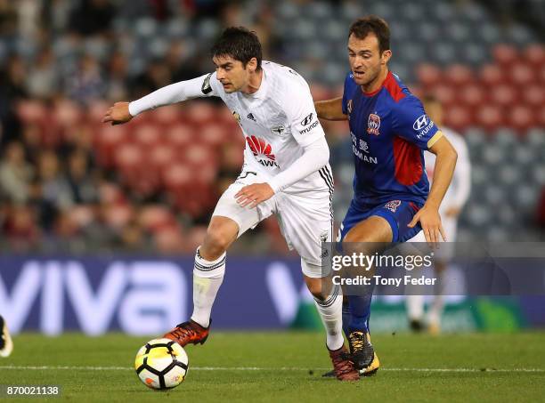 Guilherme Finkler of the Phoenix contests the ball with Ben Kantarovski of the Jets during the round five A-League match between the Newcastle Jets...