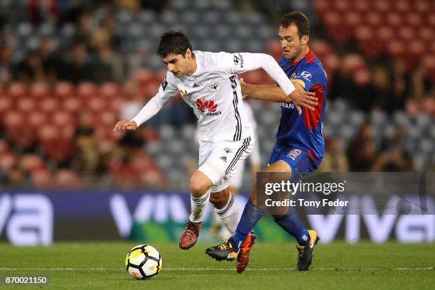 Guilherme Finkler of the Phoenix contests the ball with Ben Kantarovski of the Jets during the round five A-League match between the Newcastle Jets...