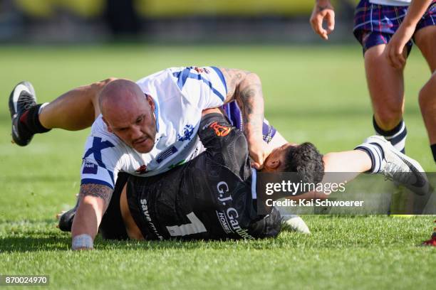 Dale Ferguson of Scotland tackles Roger Tuivasa-Sheck of the Kiwis during the 2017 Rugby League World Cup match between the New Zealand Kiwis and...