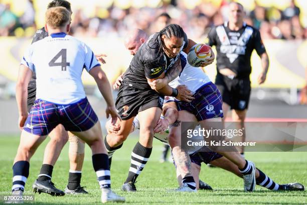 Martin Taupau of the Kiwis is tackled by Dale Ferguson of Scotland during the 2017 Rugby League World Cup match between the New Zealand Kiwis and...