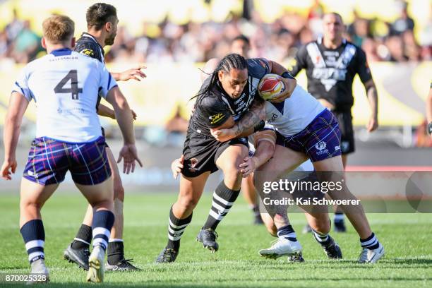 Martin Taupau of the Kiwis is tackled by Dale Ferguson of Scotland during the 2017 Rugby League World Cup match between the New Zealand Kiwis and...