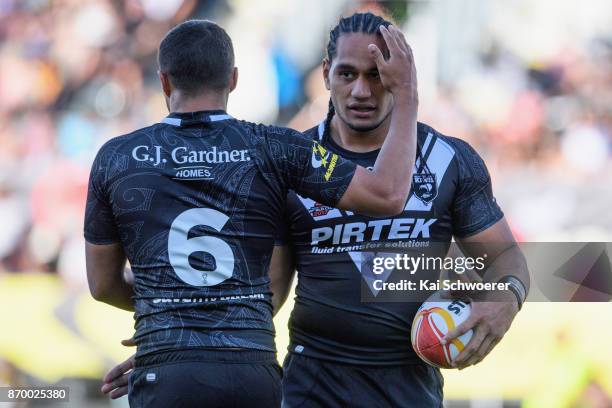 Te Maire Martin is congratulated by Martin Taupau of the Kiwis after scoring a try during the 2017 Rugby League World Cup match between the New...