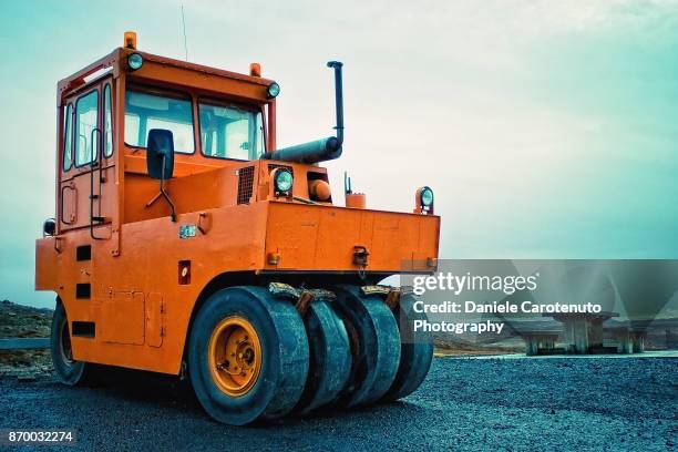 orange wheels - asphalting stock pictures, royalty-free photos & images