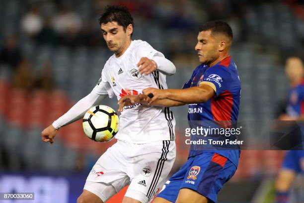Guilherme Finkler of the Phoenix contests the ball with Andrew Nabbout of the Jets during the round five A-League match between the Newcastle Jets...