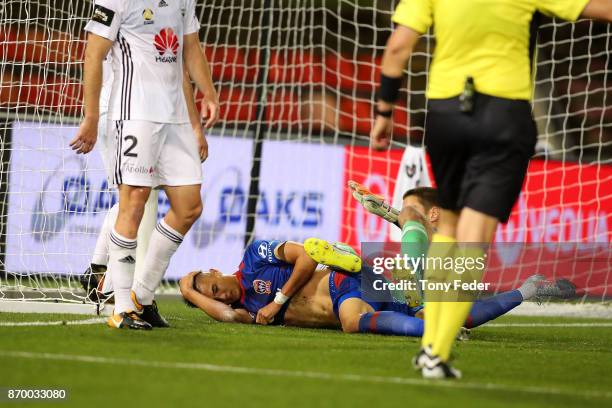 Joseph Champness of the Jets is injured after colliding with the goalkeeper during the round five A-League match between the Newcastle Jets and the...