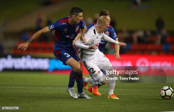 Jason Hoffman of the Jets contests the ball with Adam Parkhouse of the Phoenix during the round five A-League match between the Newcastle Jets and...