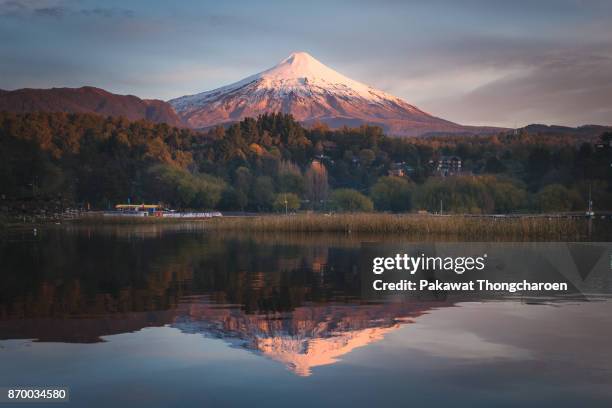 reflection of villarrica volcano at sunset, pucon, chile - pucon stockfoto's en -beelden