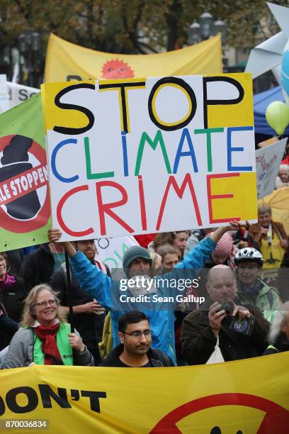 Activists hold up banners as they gather at a protest march to demonstrate against coal energy on November 4, 2017 in Bonn, Germany. The march,...