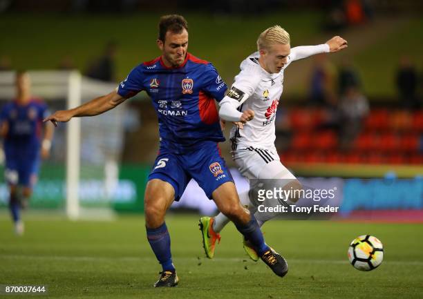 Ben Kantarovski of the Jets contests the ball with Adam Parkhouse of the Phoenix during the round five A-League match between the Newcastle Jets and...