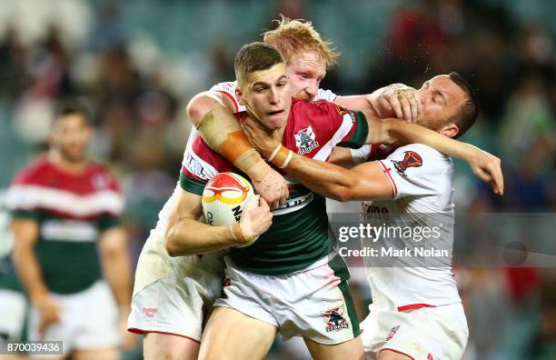 Adam Doueihi of Lebanon is tackled by Josh Hodgson of England during the 2017 Rugby League World Cup match between England and Lebanon at Allianz...