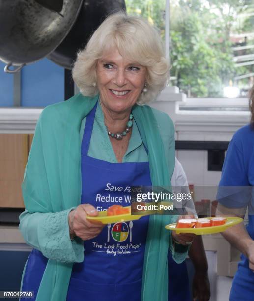 Camilla, The Duchess of Cornwall serving food for residents at The Lighthouse Children's Welfare Centre, during a visit to The Lost Food Project -...