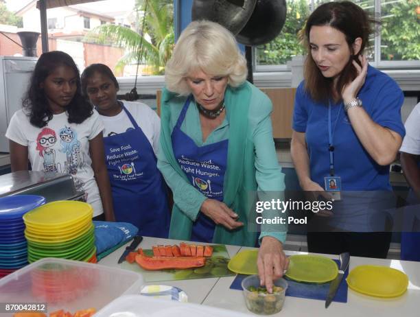 Camilla, The Duchess of Cornwall helps prepare food for residents at The Lighthouse Children's Welfare Centre, during a visit to The Lost Food...