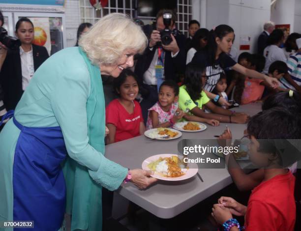 Camilla, The Duchess of Cornwall serving food for residents at The Lighthouse Children's Welfare Centre, during a visit to The Lost Food Project -...