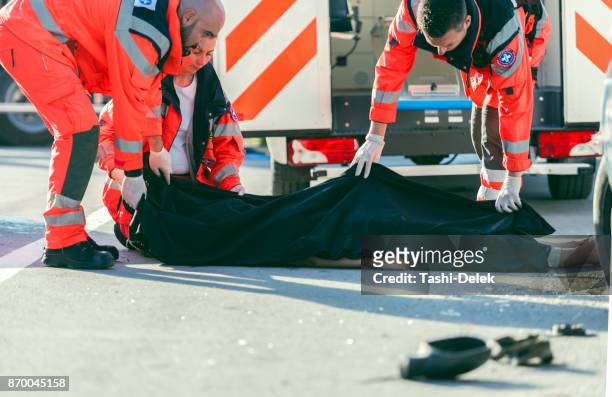 paramedic coved dead body - dead bodies in car accident photos stock pictures, royalty-free photos & images