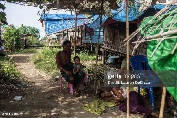 Rakhine Buddhist man sits at his family home in what is left of the Narzi Quarter on November 4, 2017 in Sittwe, Myanmar. The Narzi Quarter was once...